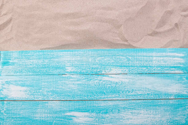 istock Sand copy space. Sand background top view. Wooden background on sand top view 1396272272