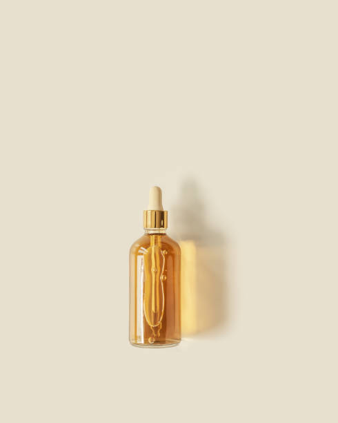istock Liquid product packaging in glass bottle on pastel beige background and  beautiful shadow. Hyaluronic or polyglutamic acid oil cosmetic mock up. Facial cosmetics, minimal trend, top view 1396272980