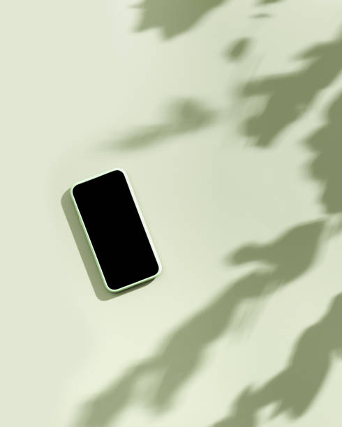 istock Mock up phone with black blank screen, minimal flat lay on pastel neutral green background. Summer lifestyle scene with smartphone, sunlight shadows, sunlight with leaves shadow, copy space 1396273034