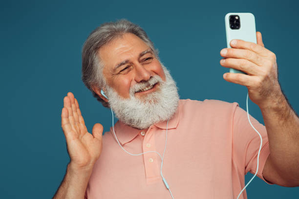 istock Portrait of emotional old man using smart phone 1396275645