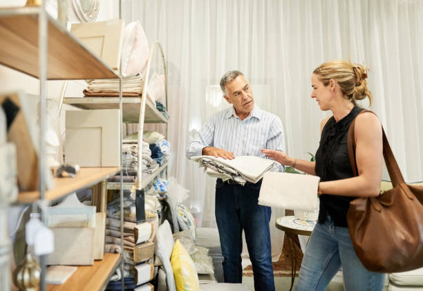 istock Woman client looking at fabric samples in interior design store 1396276880