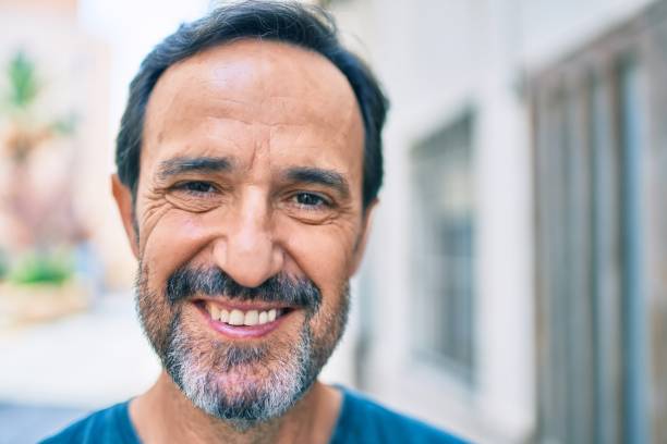 istock Middle age man with beard smiling happy outdoors 1396277068