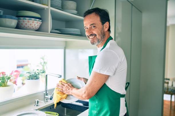 istock Middle age man with beard smiling happy washing dishes at home 1396277084