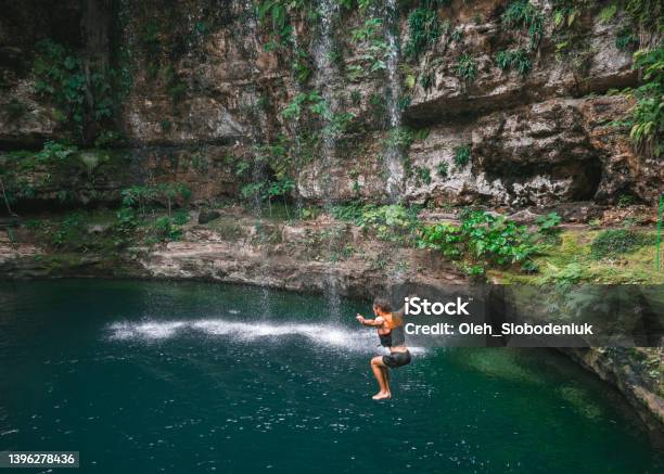 Man Jumping Into Cenote In Yucatan Mexico Stock Photo - Download Image Now - Cenote, Mexico, Tulum - Mexico