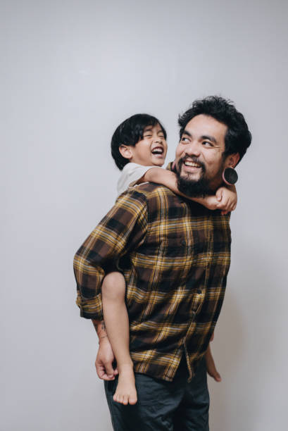 istock Affectionate father and son embracing at home. 1396278723