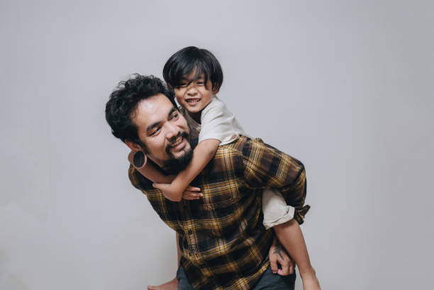 istock Affectionate father and son embracing at home. 1396278852