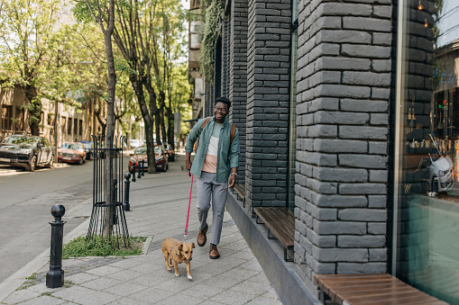 Young man walking his dog and enjoying
