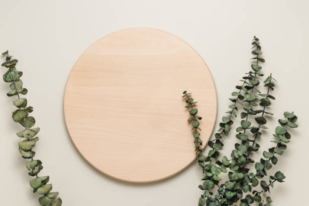 istock Round wooden podium or stand with eucalyptus leaves top view 1396282477
