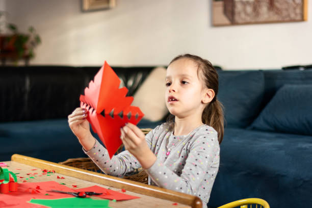 istock Child making Christmas decoration at home 1396282589