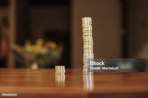 Two Coin Stacks With Very Different Size Stock Photo - Download Image Now - Currency, Growth, Imbalance