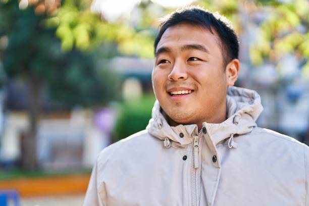 istock Young chinese man smiling confident standing at park 1396283526
