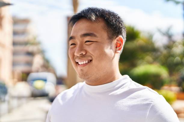 istock Young chinese man smiling confident standing at street 1396283590