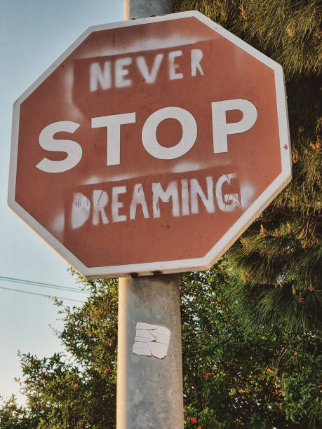 istock Traffic sign of stop with message never stop dreaming 1396286769