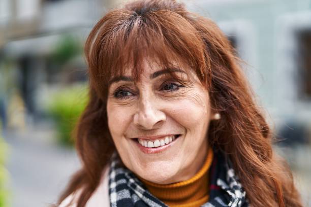 istock Middle age woman smiling confident standing at street 1396288405