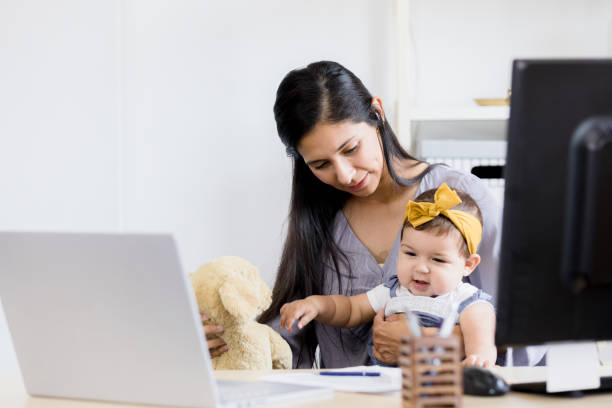 istock Work-from-home mother plays with baby during break from meetings 1396288897
