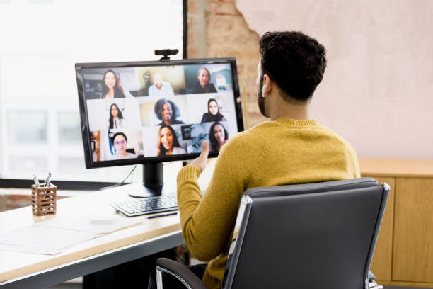 istock Over-the-shoulder view diverse team as unrecognizable man leads online meeting 1396288920