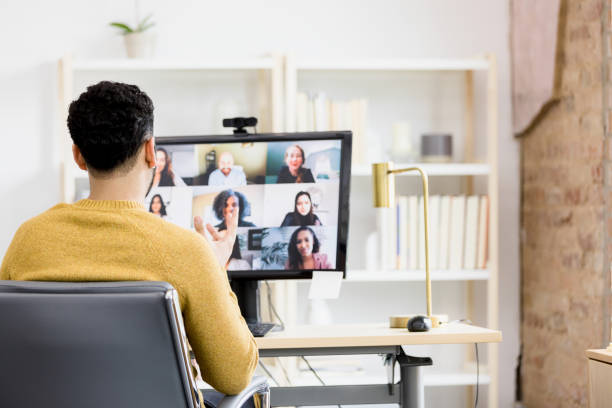 istock Rear view man leading online meeting 1396288926