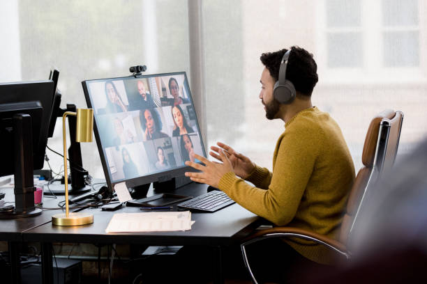 istock Hot desking, business man leads virtual team meeting 1396288948