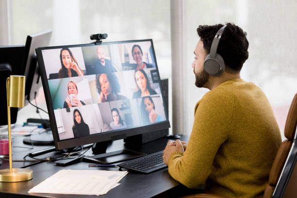 istock Young man hot desks to attend video meeting with co-workers 1396288974