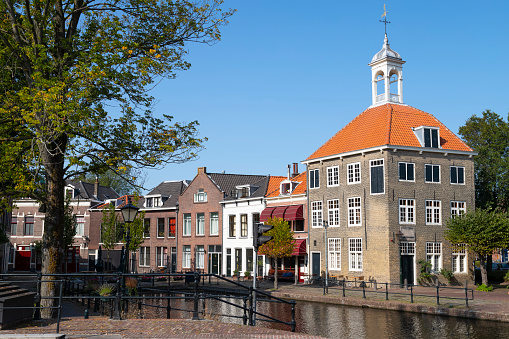 Two People Riding Bikes in Dutch Town Near Canal. Shot in Sneek, Friesland, Netherlands.