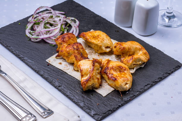 istock chicken kebab with red onion on a black stone plate 1396291578