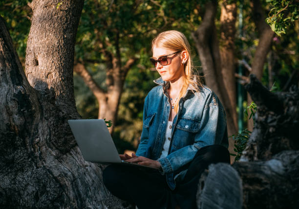 istock Blonde Woman Working With Laptop on the Park 1396293207