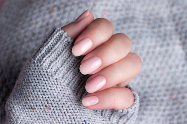 istock Hand in sweater with nude nails 1396293521