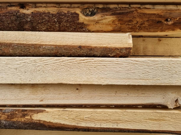 istock Stacked pine boards. Low quality lumber. Selective focus 1396293756