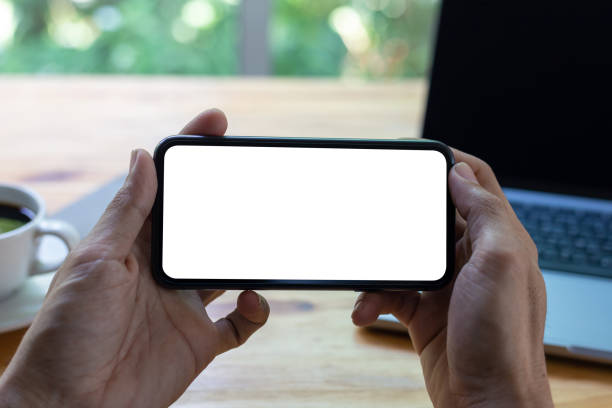 istock man hand using smartphone In the office Screen blank with clipping path ,Top view mockup image of male holding mobile phone with empty white screen 1396294860