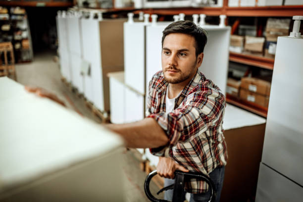 istock Young casually clothed  man working late in distribution center 1396297035