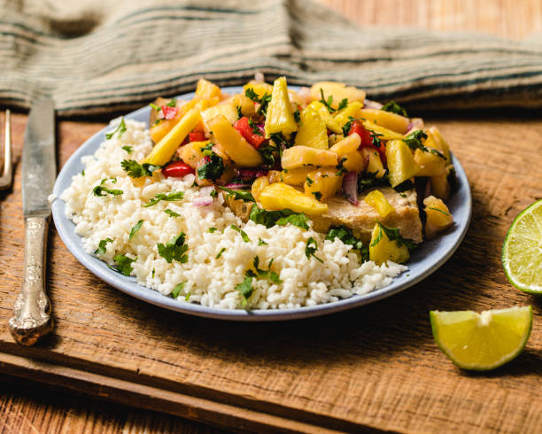 istock a dinner plate of swordfish with pineapple salsa served with cauliflower rice and limes 1396297284