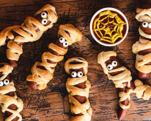 istock Hotdogs wrapped in crescent rolls designed to look like mummies. with eyes 1396297331