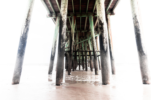 Beach pier shows its elements from dawn to dusk at Amelia Island, Florida, USA