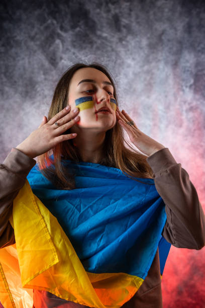 all the emotions of pain, sadness and fear on the face of a young Ukrainian woman. war of Russia all the emotions of pain, sadness and fear on the face of a young Ukrainian woman with a flag and hope for peace. war of Russia grimma stock pictures, royalty-free photos & images