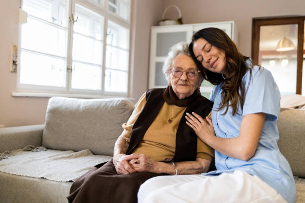 istock Young medical worker hugging her senior patient at home visit 1396300809