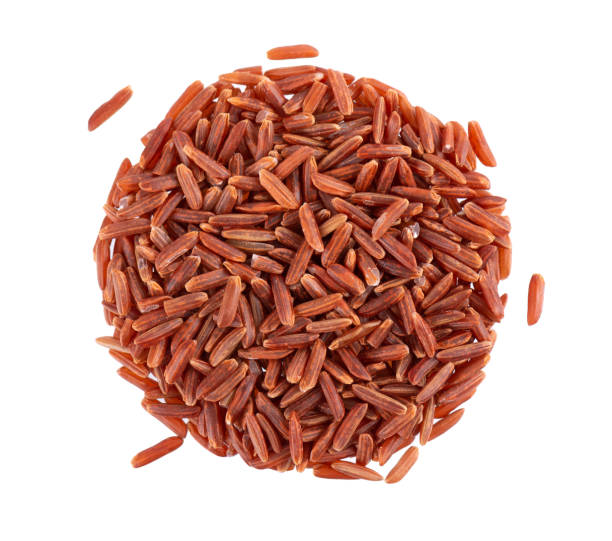 istock Red rice isolated on white background. Whole grain raw brown rice. Top view. 1396301466