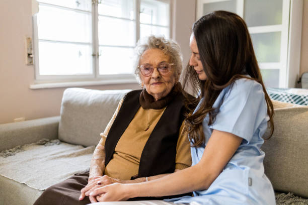 istock 90 year old lady with her nurse during home visit 1396301489