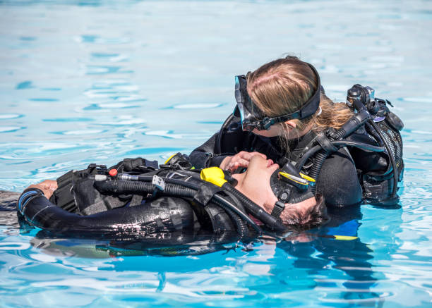istock Scuba Diving rescue course surface skills checking for breathing 1396301508