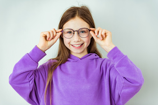 Photo of young happy girl happy positive smile wear glasses vision ophthalmology isolated over gray color background