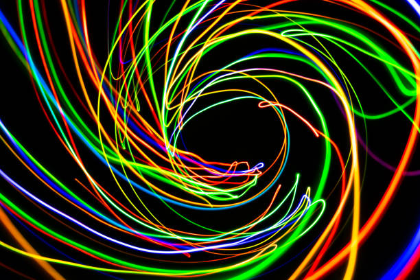 istock Color Light LED Bulb moving in the dark on long exposure shot 1396306930