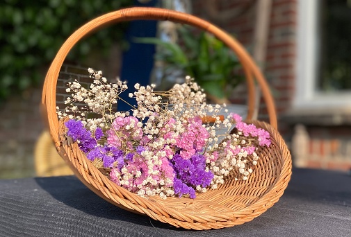 Dry flowers as decoration in a wicker basket