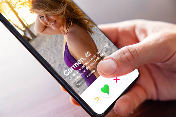 istock Man using online dating app on phone and viewing someone's profile photo 1396307675