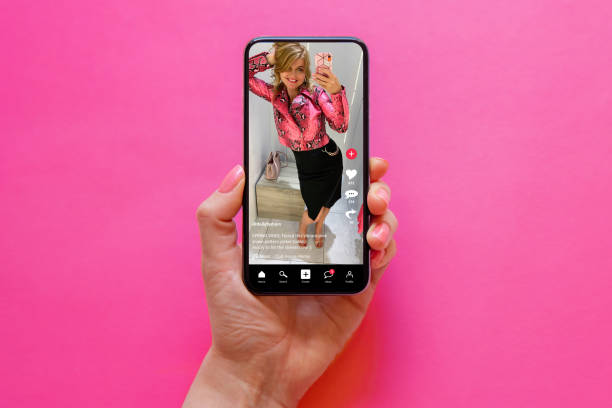 istock Sample social media app with shared video content on screen, concept of people using social media platforms for creating and sharing content. 1396307698