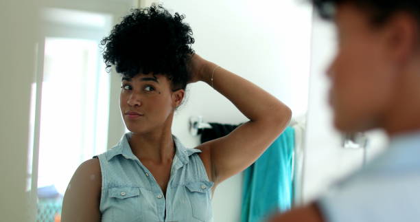 istock Young mixed race woman getting ready in front of bathroom mirror 1396308330