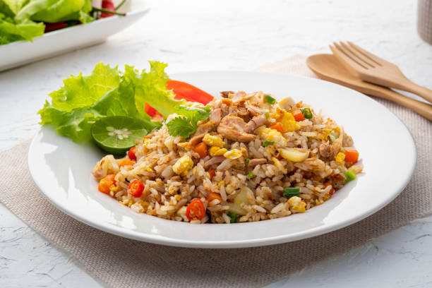 Fried Rice with canned Tuna fish Fried Rice with canned Tuna fish.Quick and Easy Thai style spicy one dish meal on white plate fried rice stock pictures, royalty-free photos & images