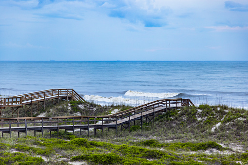 Boardwalk bridges between inland and beach, leads to the ocean. Amelia Island, Florida, USA