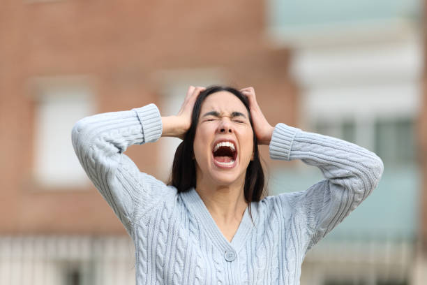 Mad woman yelling in the street stock photo