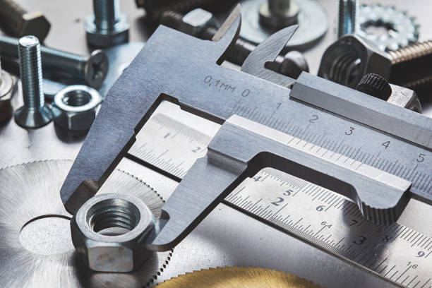 set of different nuts, bolts, screws, washers and drill bits,thread tap and mill cutters on steel plate background. Locksmithing deal.