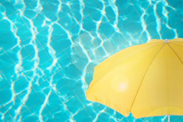 istock Open beach umbrella and swimming pool. Summer vacation 1396317894
