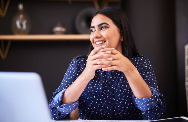 istock Young indian businesswoman drinking coffee while working alone in an office. One female only taking a break and looking thoughtful while enjoying a warm cup of tea at her desk 1396322708